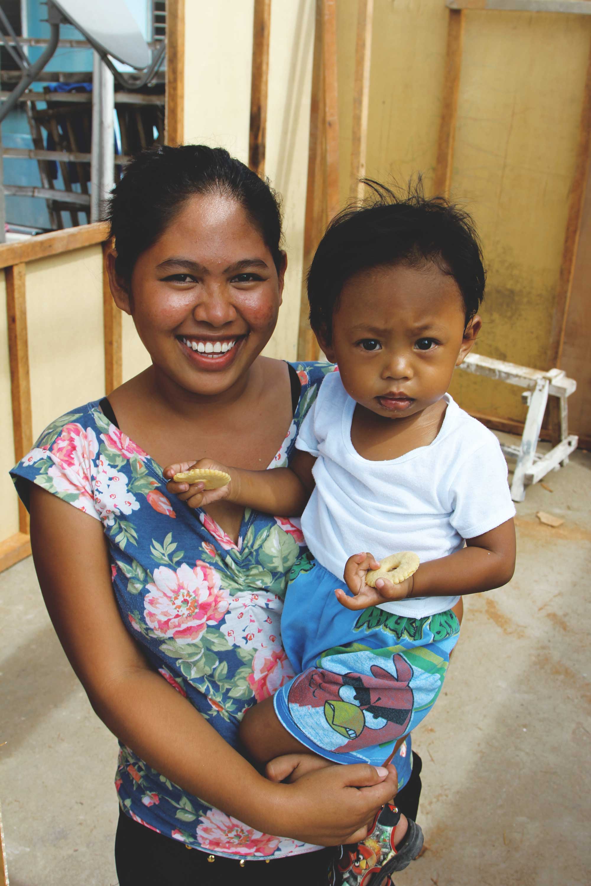 Margorie stands in her new home built by Convoy of Hope.