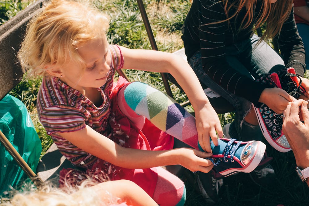 One of Tonya's daughters tries on her new pair of shoes provided by the local community.